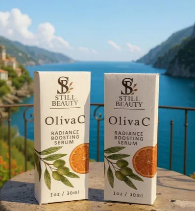 Two pack Still Beauty OlivaC radiance boosting serum bottle boxes with scenic Mediterranean background of a coastal town and blue sea.