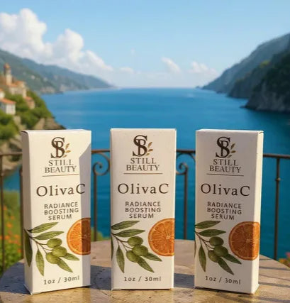 Three pack of Still Beauty OlivaC radiance boosting serum bottle boxes with scenic Mediterranean background of a coastal town and blue sea.